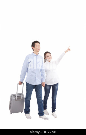Young couples pulling suitcase Stock Photo