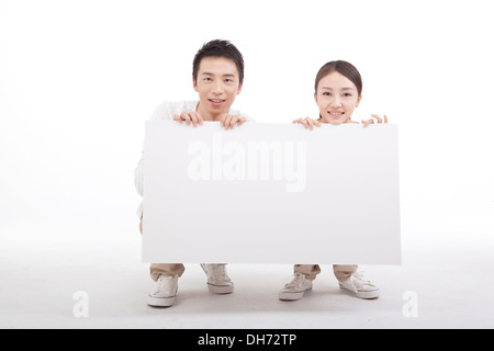 A pair of young couples and whiteboard Stock Photo
