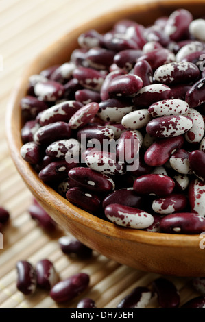 Wooden bowl full of red kidney bean variety Stock Photo