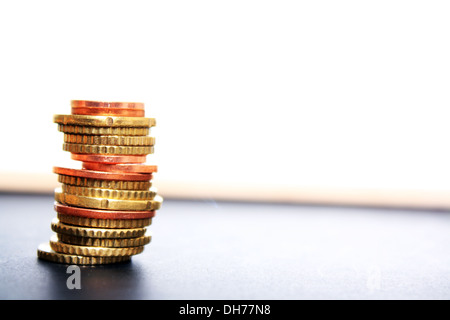 Stack of coin on ground with white background Stock Photo