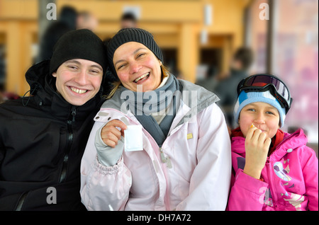 Family skiers wearing winter ski gear Stock Photo