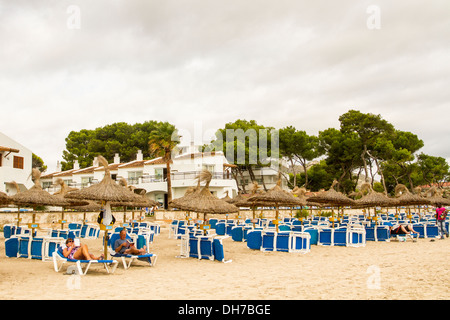 Umbrellas in Muro beach, Mallorca. Stock Photo