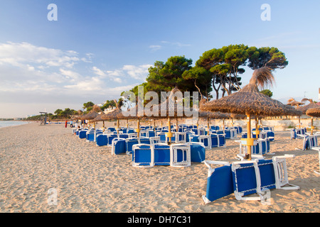 Umbrellas in Muro beach, Mallorca. Stock Photo