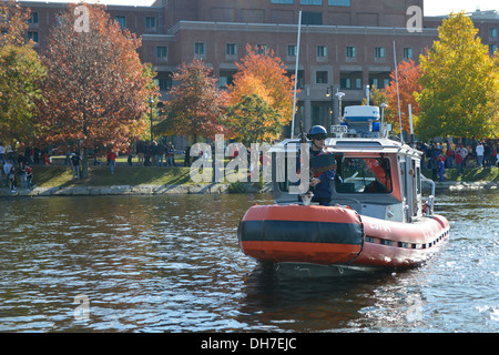 Coast Guard Station Boston crews patrol the Charles River in Boston during the Red Sox parade Nov. 2, 2013. Numerous federal, state and local law-enforcment teams kept a safety zone around the baseball player's boats during the parade throught the city. Stock Photo
