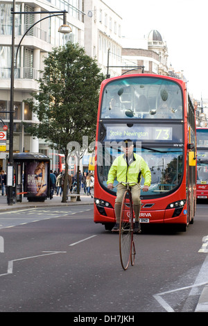 Man on a Penny-farthing riding down Regent Street in London england Stock Photo