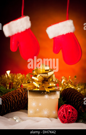 Christmas gifts arranged on a table with spruce branches and lights Stock Photo