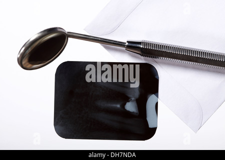 x-ray of tooth film detail and dental instrument isolated on white Stock Photo