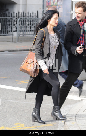 Lucy Liu and Jonny Lee Miller on set of new CBS series 'Elementary' in lower Manhattan New York City USA - 20.03.12 Stock Photo