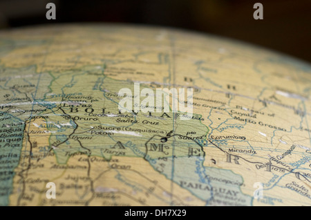 A map of Bolivia on an antique globe. Stock Photo