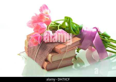 Pink tulips on old books Stock Photo