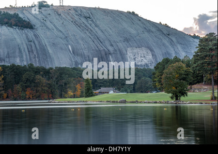 Autumn lake view at dusk of Stone Mountain Park with Confederate Memorial Carving, golf course, riverboat, and Summit Skyride. (USA) Stock Photo