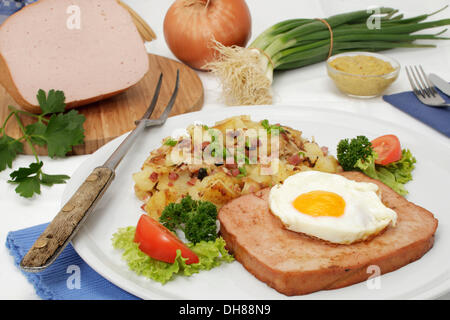 Leberkaese with fried egg and fried potatoes, Bavarian speciality