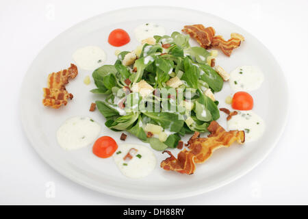 Field salad with potato dressing, bread croutons and fried bacon