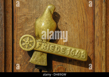 Door handle with the inscription 'Friede 1648', German for 'Peace 1648' by Fritz Szalinski, at the front door of the Osnabrueck Stock Photo