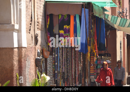 Good for sale in Marrakech, with colourful blankets, rugs and throws hanging outside. Stock Photo