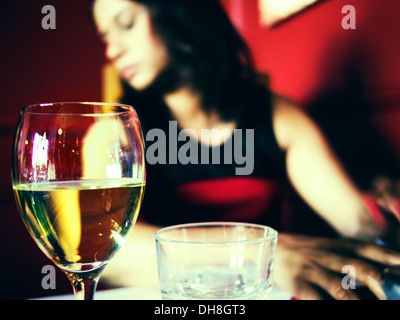 Glass of wine and woman in restaurant Stock Photo