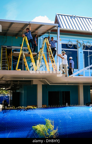 Workmen refabricating the roof on Venice Pier Pavillion Florida Stock Photo