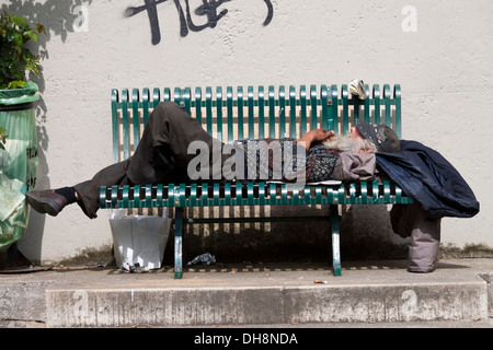 Man sleeping on a Bench in Paris, France Stock Photo