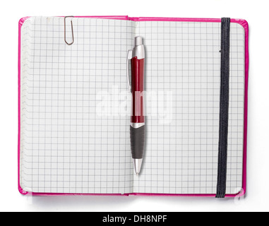 blank page of pink note book with paper clip and elastic strap and a red ball pen, isolated on white. Stock Photo