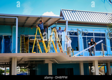 Workmen refabricating the roof on Venice Pier Pavillion Florida Stock Photo