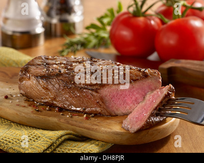 Sliced Grilled Tri Tip Steak on cutting board Stock Photo