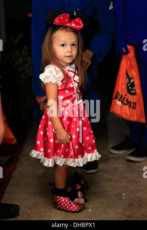 Little girl dressed in a Minnie Mouse costume on Halloween night Stock Photo