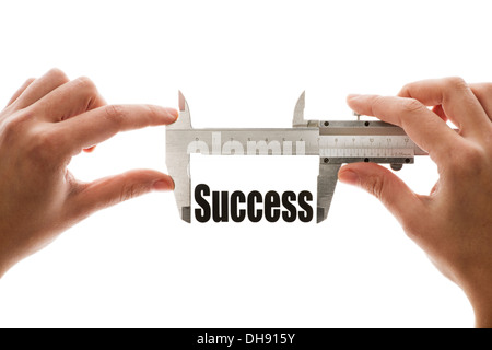 Close up shot of a caliper measuring the word 'Success' Stock Photo