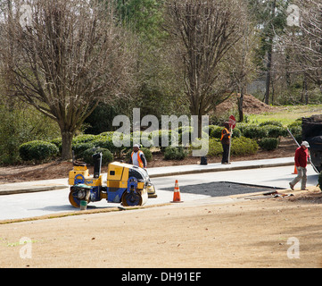 Patching Crew Road crew and paver Stock Photo - Alamy