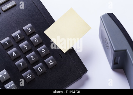 memo post it message on telefone in office reminder object business Stock Photo