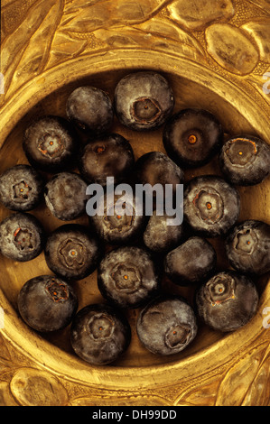 Blueberry,  Vaccinium corymbosum Royal Blue 1. Looking down  on Blueberries lying in ornate pewter plate. Stock Photo