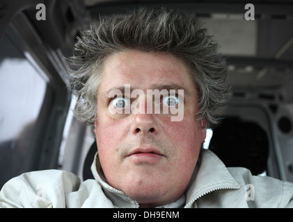 Wide eyed, odd expression on the face of a middle aged white male. Stock Photo