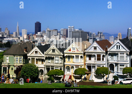 Victorian row houses Painted Ladies near Alamo Square and view over the San Francisco skyline, California, US Stock Photo