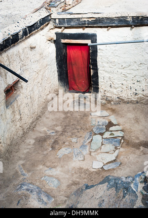 Colored door curtain at house entrance in small Tibetan village in mountains. India, Ladakh, Diskit monastery Stock Photo