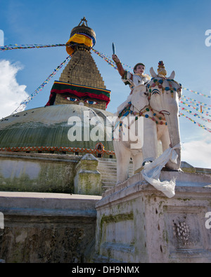 Buddhist Shrine Boudhanath Stupa with pray flags over blue sky. Nepal, Kathmandu Stock Photo