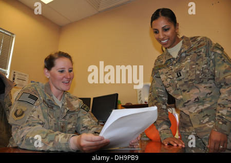 Capt. Dimple Nolly, 455th Air Expeditionary Wing deputy staff judge advocate, deployed from Spangdahlem Air Base, Germany, and a Houston native, talks with Staff Sgt. Megan Stockinger, 455th Air Expeditionary Wing NCO in charge of military justice, deploy Stock Photo