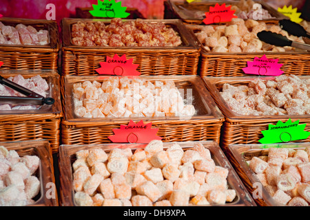 Selection of Turkish Delight sweets candy displayed in baskets on a market stall England UK United Kingdom GB Great Britain Stock Photo