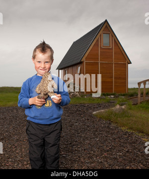 Young boy holding his stuffed animal, Eskifjordur, Iceland Stock Photo