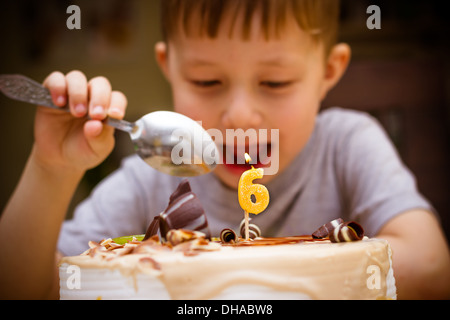 The boy looks at the birthday cake Stock Photo