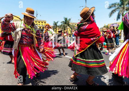 Indians in traditional peruvian dresses dancing in the square Plaza de Armas, Lima, Peru Stock Photo