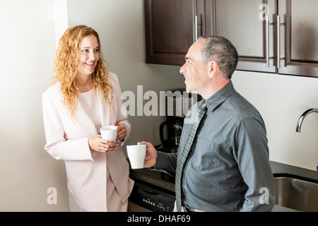 Business colleagues having conversation in office coffee break area Stock Photo