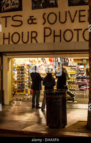 Tourists posing with a statue of Elvis at a souvenir shop on Hollywood Blvd in Hollywood California Stock Photo