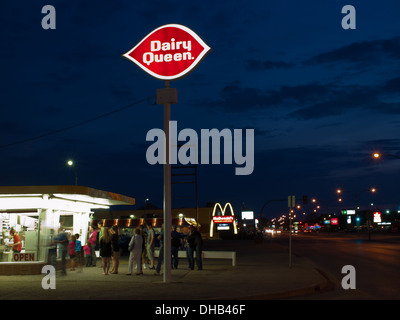 A nighttime view of a crowd waiting in line for ice cream at the Dairy Queen on 1722 - 8th Street in Saskatoon, Canada. Stock Photo