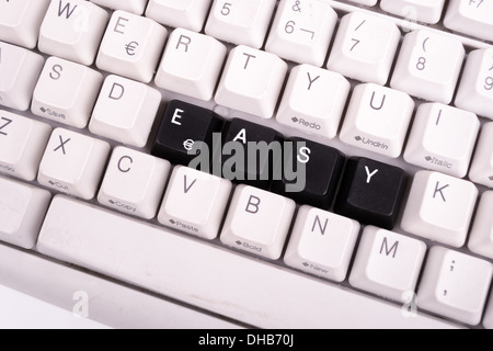 Word Easy written with black keys on computer keyboard. Stock Photo