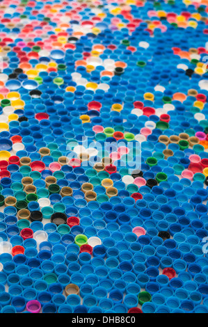 Colorful plastic bottle caps in a row Stock Photo