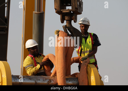 Mining in Africa. Crane lift of mining equipment Stock Photo