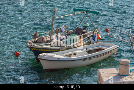Two wooden fishing boats stay moored in Petrovac town, Montenegro Stock Photo