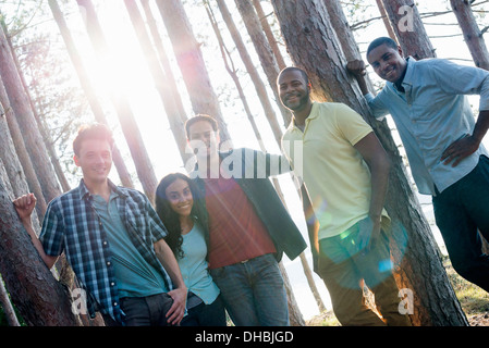 Lakeside.  A  friends gathered in the shade of pine trees in summer. Stock Photo