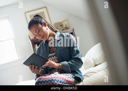 A young woman using a digital tablet. Stock Photo