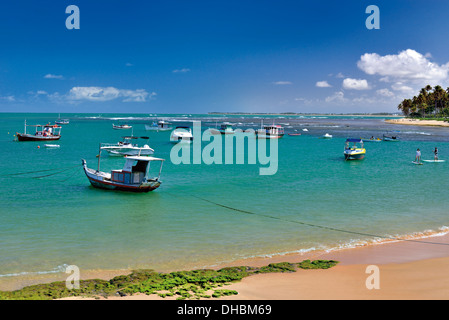 Brazil, Bahia: Boats anchoring in the calm waters of beach Praia do Forte Stock Photo