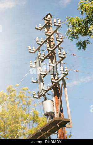Old fashioned telephone pole and blue sky, Sweden Stock Photo